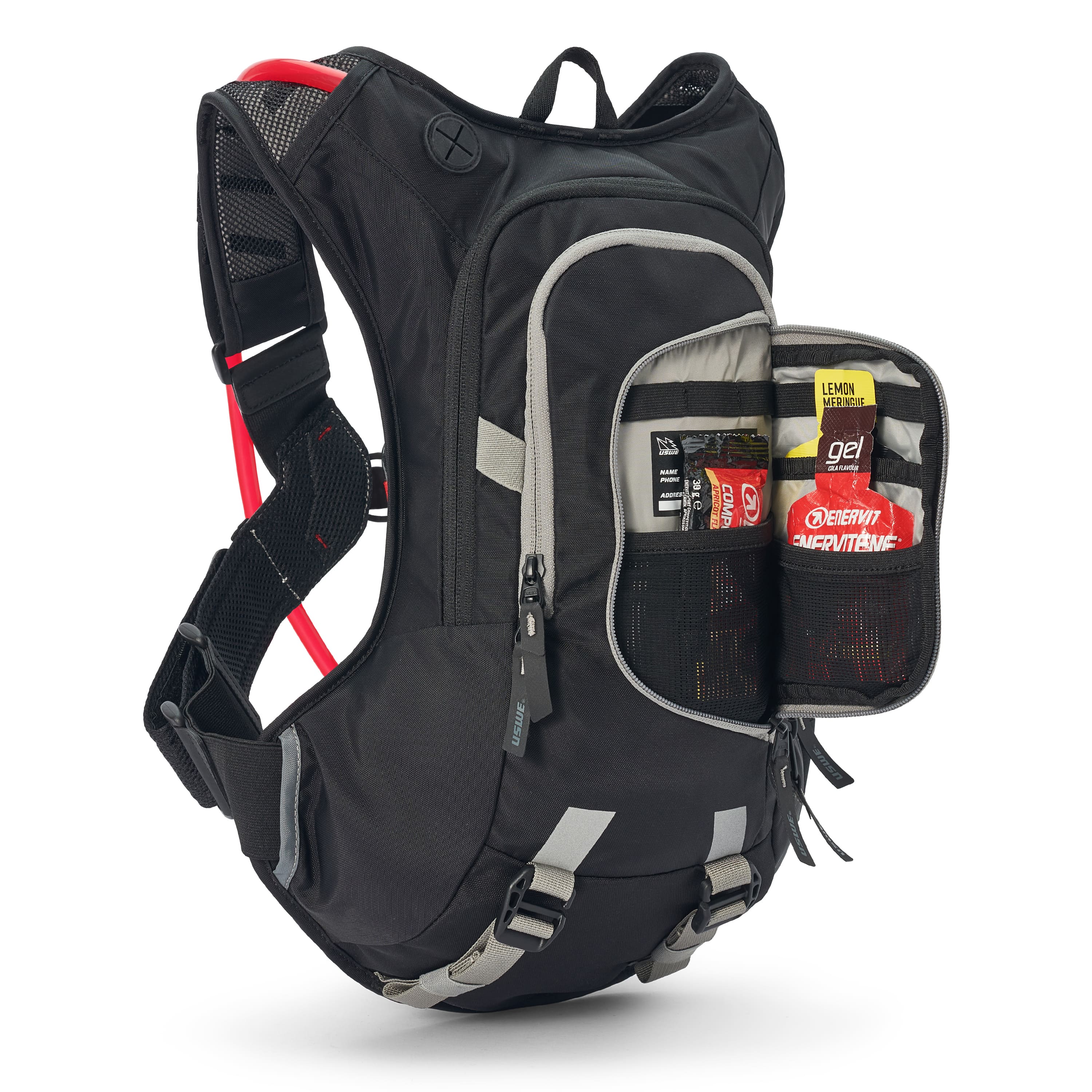 USWE Moto Hydro 12L hydration pack displayed with front compartment unzipped to reveal organized storage pockets holding energy gels, nutrition packets, and tools, showing the pack's 12-liter cargo capacity for dirt bike and enduro riding.