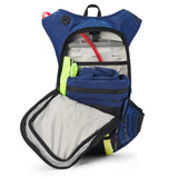 USWE Moto Hydro 12L hydration pack fully unzipped showing internal layout with 3.0L Elite Hydration Bladder in dedicated compartment, neon yellow gloves in side pocket, and lower storage area with blue compression straps for organizing motorcycle gear.