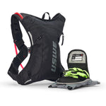 USWE Moto Hydro 3L hydration pack with detachable front organizer pocket opened to reveal emergency information card and bright green gloves stored inside, alongside gray hydration bladder laid flat.