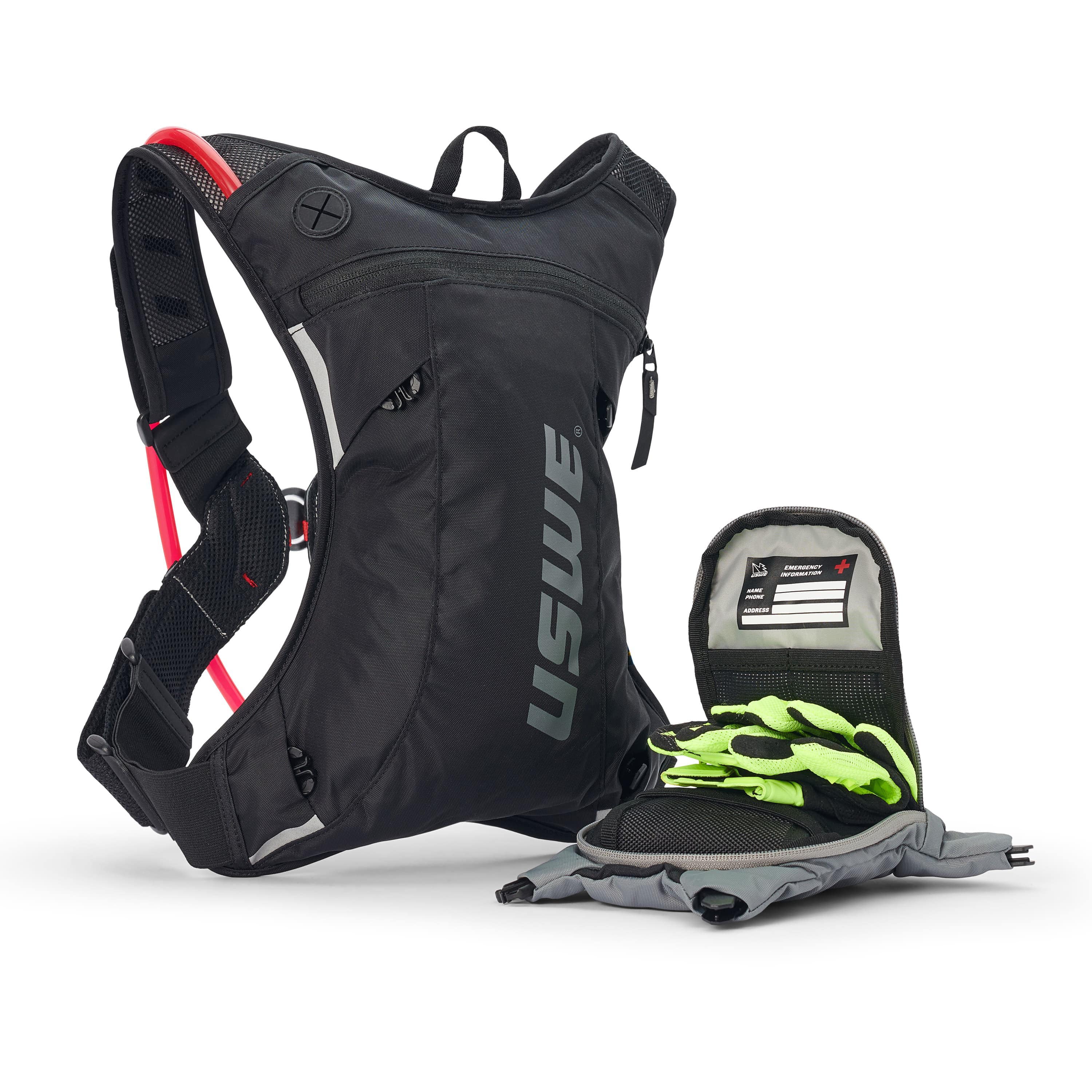 USWE Moto Hydro 3L hydration pack with detachable front organizer pocket opened to reveal emergency information card and bright green gloves stored inside, alongside gray hydration bladder laid flat.