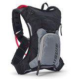 USWE Moto Hydro 3L hydration pack in black and gray with detachable front organizer pocket, mesh shoulder straps, and red hydration bladder visible inside main compartment.