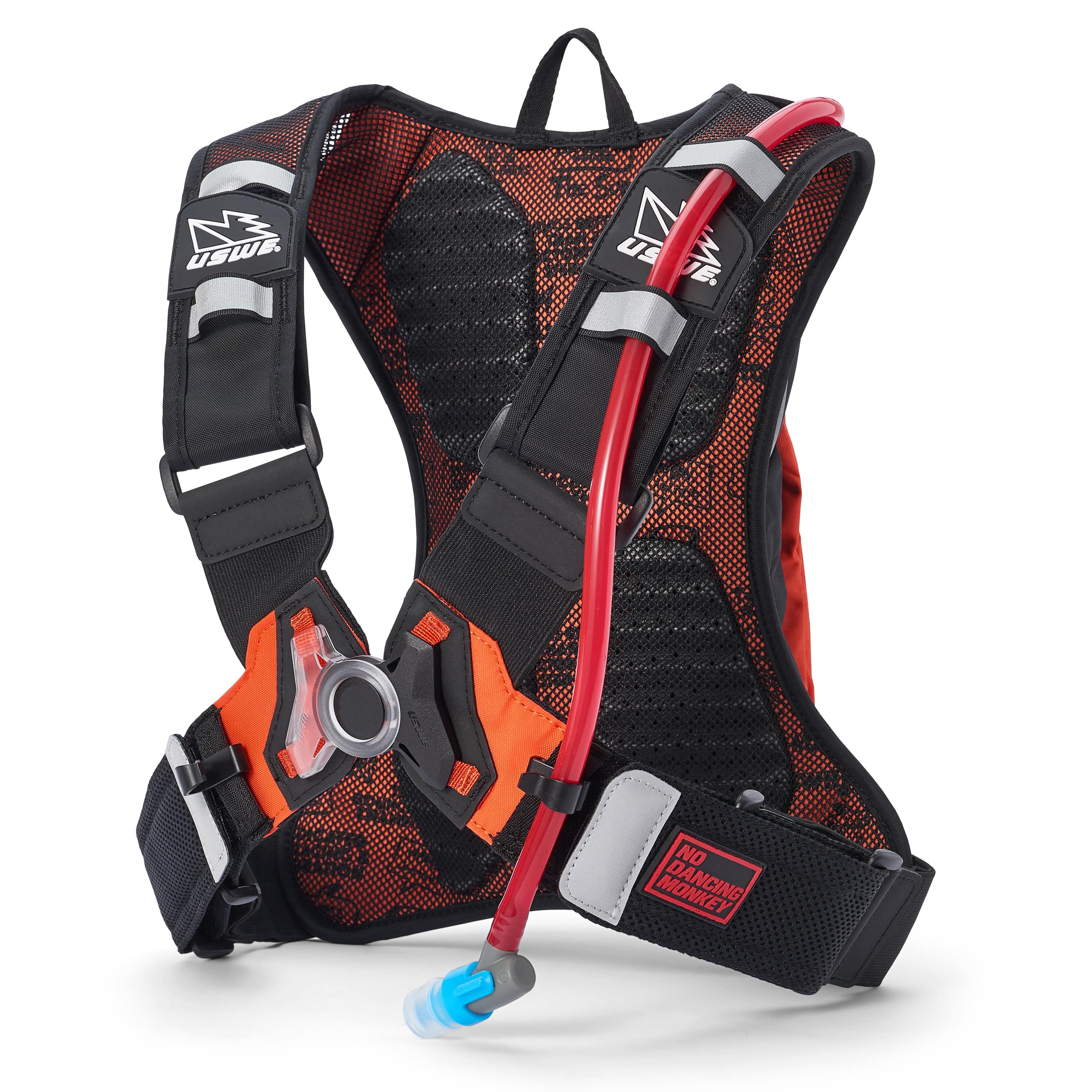 USWE Moto Hydro 3L hydration pack in black and orange with red hydration tube secured in diagonal mesh sleeve, elastic NDM harness straps with white USWE lightning bolt logos, orange waist belt with black buckle, and No Dancing Monkey patch on lower belt.