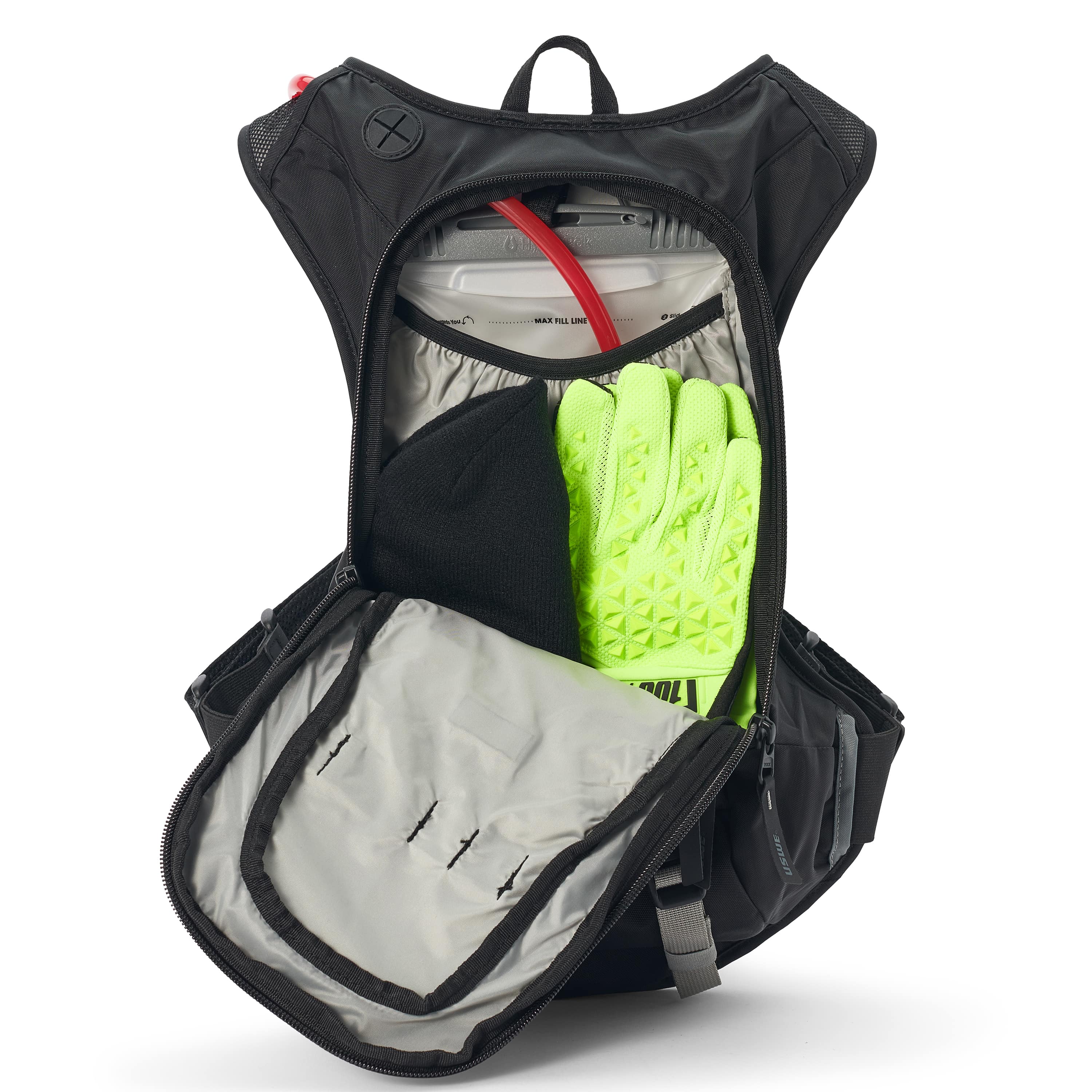 USWE Moto Hydro 8L hydration pack fully opened to display main compartment loaded with 3.0L Elite Hydration Bladder, bright yellow-green riding gloves, and internal storage dividers, demonstrating the pack's 8L carrying capacity for dirt bike gear and accessories.
