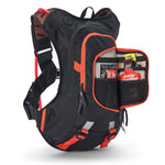 USWE Moto Hydro 8L hydration pack in black with orange trim, front organizer pocket unzipped and extended to show Enervit energy gels and nutrition sachets stored in mesh dividers, with orange waist belt compression straps and reflective gray accents on the harness system.