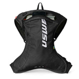 USWE OUTLANDER Moto 2L hydration pack in black with vertical white logo branding, shown laid flat to display the contoured ergonomic shape, elastic side panels, and top compartment with visible 1.5L hydration bladder for dirt bike racing.
