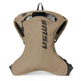USWE OUTLANDER Moto 2L hydration pack in sand with main compartment unzipped to reveal the 1.5L Elite Hydration Bladder inside, showing the curved ergonomic body shape and elastic side compression panels for a locked-down fit during dirt bike riding.