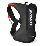 USWE OUTLANDER 4L hydration pack in black with white vertical branding, photographed from side angle showing elastic shoulder straps, adjustable waist belt, and red hydration bladder visible at top opening.