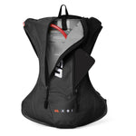 Black USWE OUTLANDER 4L hydration pack displayed with main compartment fully open, exposing 3L Elite bladder with red hose and internal storage pocket holding smartphone, demonstrating compact organization for moto essentials.