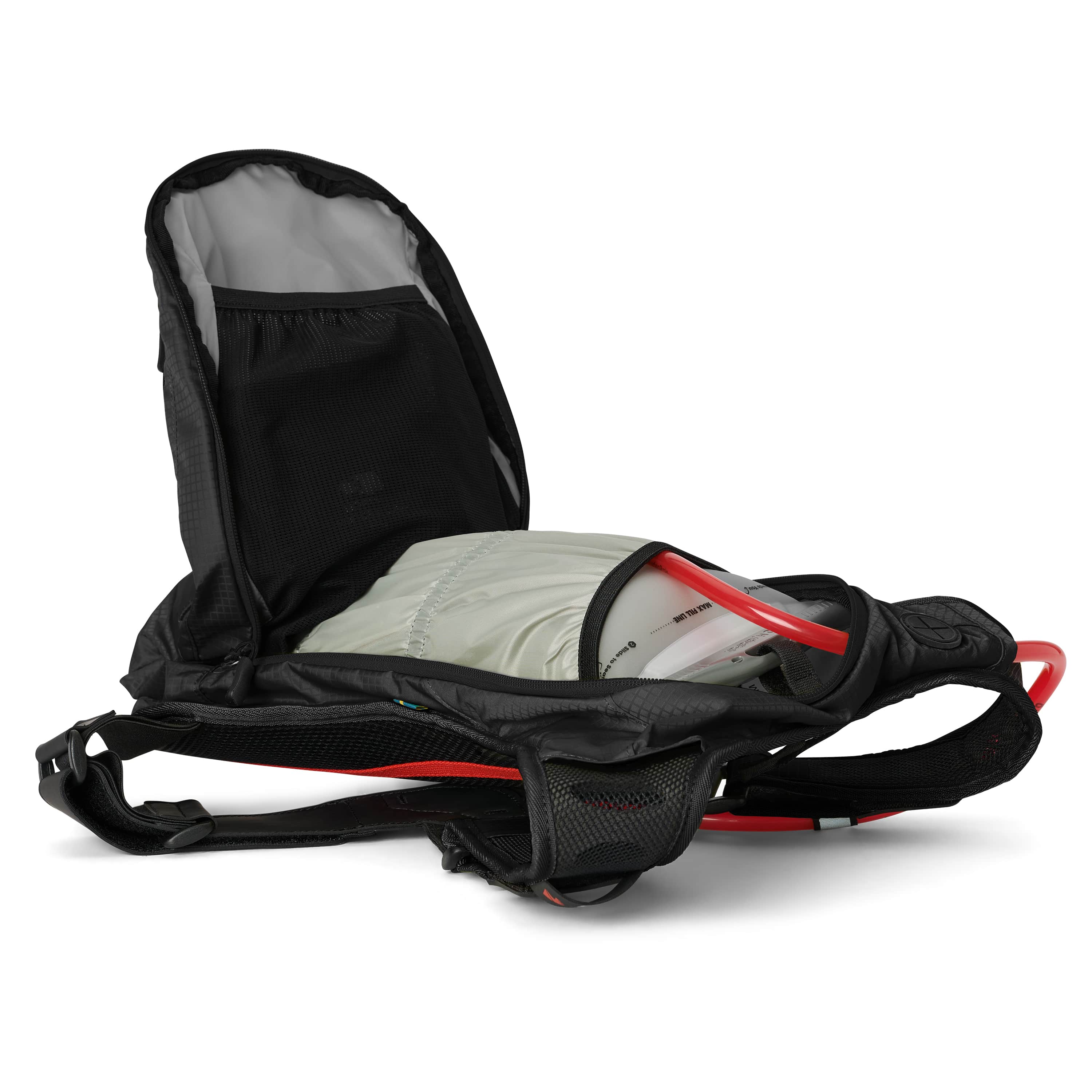 USWE OUTLANDER Moto 9L hydration pack in Black with main compartment fully unzipped revealing 3L Elite bladder with red cap nestled inside spacious cargo area with black mesh divider and gray interior lining.