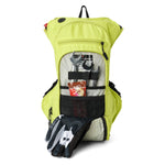 USWE OUTLANDER Moto 9L hydration pack in Crazy Yellow with front compartment unzipped displaying organized tool storage including wrenches, energy gel, and riding gloves secured with elastic straps and mesh pockets.