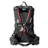USWE VST Termocell Winter Harness with insulated shoulder strap pockets and red elastic straps shown on black hydration backpack from rear view. The Termocell thermal insulation system features body heat trapping pockets along both shoulder straps to prevent hydration tube freezing in cold weather conditions.