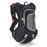 USWE Moto Hydro 8L hydration pack in black and gray with elastic No Dancing Monkey harness straps, front zippered pocket, and integrated hydration bladder compartment for dirt bike and enduro riding.