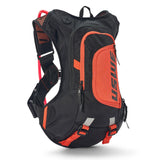USWE Moto Hydro 8L hydration pack in black with orange accents, featuring No Dancing Monkey elastic shoulder harness with mesh ventilation panels, red hydration hose clip, reflective waist belt straps, and vertical USWE branding on the front zippered pocket for dirt bike riding.